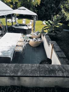 a patio with a table and chairs and an umbrella at Les hauts château in Chalifert