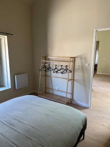 a bedroom with a bed and a rack of shoes at Appartement 2 chambres gare chateaucreux in Saint-Étienne