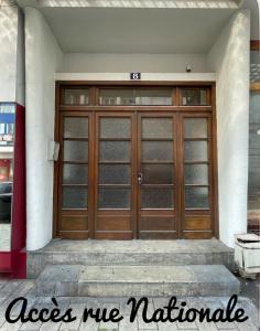 a pair of wooden doors on a building at Le cocon du Centre in Dunkerque