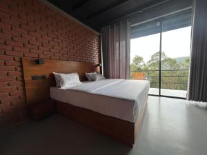 Postel nebo postele na pokoji v ubytování Camellia Lodge Ella