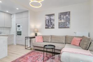 a living room with a couch and a table at Perfect Location - Modern Riverside Apartment in Warsaw