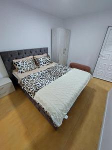 a bedroom with a bed with a black and white comforter at Darija 1 in Herceg-Novi