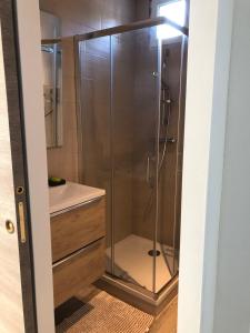 a shower with a glass door in a bathroom at Charming 38m2 city house in Le Cannet +7 photos