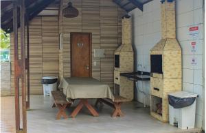 a kitchen with a table and a sink in a room at Porto de Galinhas Pé na Areia Belize in Porto De Galinhas
