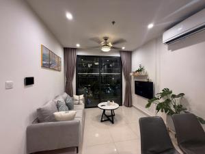 a living room with a couch and a table at Moon Homestay 0308 in Gia Lâm Pho