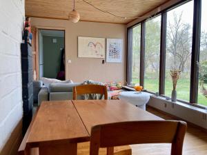a living room with a table and a couch at Near beach summer house in Farhultsbaden in Farhult