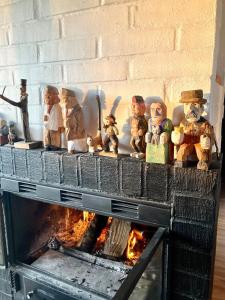 a group of figurines sitting on top of a fireplace at Near beach summer house in Farhultsbaden in Farhult