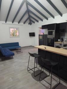 a living room with a blue couch and chairs at Villa Lilisse in Le Moule