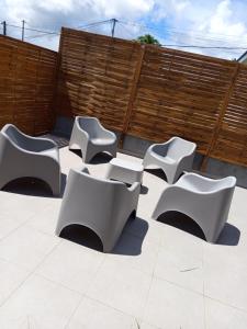 a group of white chairs sitting on a patio at Villa Lilisse in Le Moule