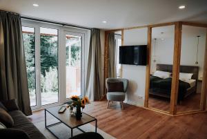 a living room with a couch and a bedroom at Ferienwohnung Goldtann in Elzach