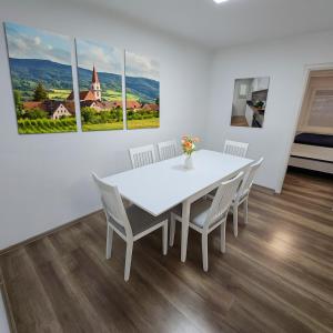 a white dining room with a white table and chairs at House with garden near Vienna & airport 