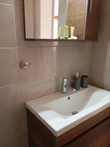 a bathroom with a white sink and a mirror at Miranda Studios in Paliouri +42 photos