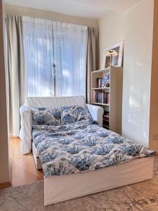 a bedroom with a bed and a window at Elegant and bright flat in a quiet area in Rīga