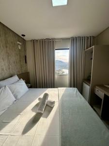 a hotel room with a bed with a towel on it at Pousada Belvedere in Capitólio +58 photos