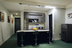 a kitchen with a island with a bowl on it at INEZA SUITEs in Kampala