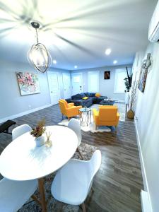 a living room with a table and chairs and a couch at Private Home Near Moncton Hospital&Downtown in Moncton
