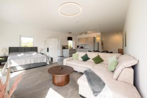 a living room with a couch and a bed at Lux Apts Deluxe Apartment-Zentral-Messe-Küche in Cologne