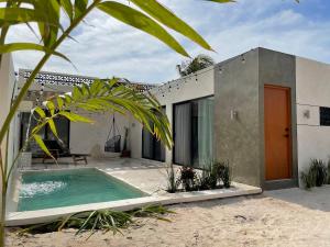 a house with a swimming pool in front of it at Casa Mia in Chuburná
