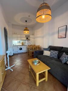 a living room with a couch and a table at El Paraíso de Isla Canela in Isla Canela