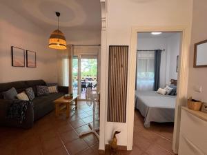 a living room with a couch and a bed at El Paraíso de Isla Canela in Isla Canela