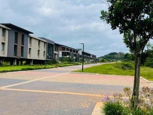 an empty street with a row of houses at Zimbali Lakes Boulevard Suites 145 in Ballito