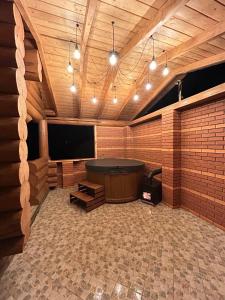 a large room with a tub and a tv at Над рікою Міжгірʼя in Mizhhirʼʼya