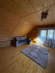 a living room with a couch and a rug at Над рікою Міжгірʼя in Mizhhirʼʼya