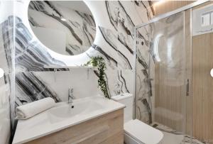 a bathroom with a sink and a toilet and a mirror at Sun Garden in Adeje +13 photos