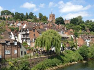 a town with a river and houses and a tree at Cosy Town House in Bridgnorth in Bridgnorth