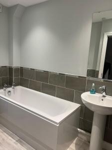 a bathroom with a white tub and a sink at Cosy Town House in Bridgnorth in Bridgnorth +14 photos