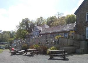 a group of picnic tables in front of a building at 23 Sea Valley, Quiet Chalet at Bideford Bay holiday park in Bideford