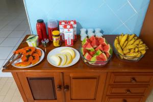 a table with three bowls of fruit on it at Hotel Brisa do Araguaia SFA in São Félix