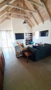 a living room with two couches and a table at Tweede Lente in St Helena Bay