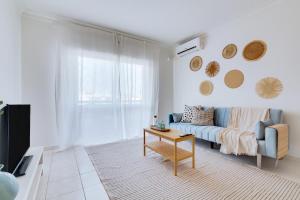 a living room with a couch and a table at Brisa Algarvia 2 in Faro
