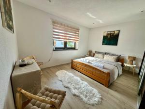 a bedroom with a bed and a chair and a window at Dom Amélia in Snina