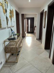 a hallway with a glass desk and a room at Dom Amélia in Snina