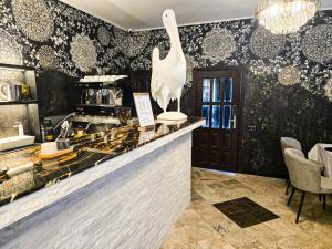 a restaurant with a swan statue on a counter at Pelican in Zagrody +24 photos