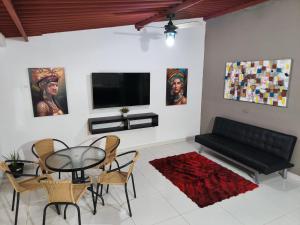 a living room with a black couch and a table at Casa Terraza in El Zaino