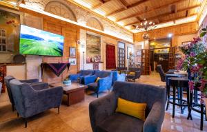 a waiting room with blue chairs and a large screen at New Imperial Hotel in Jerusalem