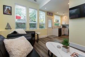 a living room with a couch and a table at Sidney Solace 1BR Suite Minutes from Waterfront in Sidney