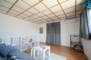 a living room with a blue couch and a table at Blue Levant Guest House in Famagusta