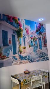 a painting of a street with a table and chairs at A due passi dal mare ,Cala paradiso in Augusta +29 photos