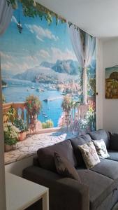 a living room with a wall mural of a city at A due passi dal mare ,Cala paradiso in Augusta