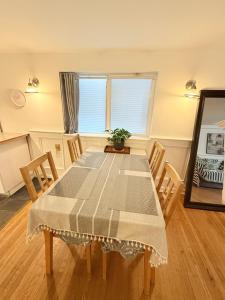 a dining room table with chairs and a window at walk distance to kits beach 2bedrooms only for you in Vancouver