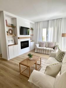 a living room with a couch and a table at Elena Playa Sol in Alcudia