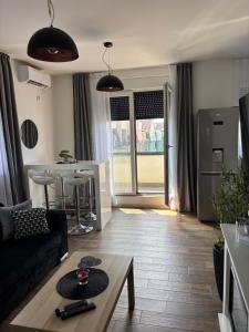 a living room with a couch and a table at Apartman Idila in Ruma
