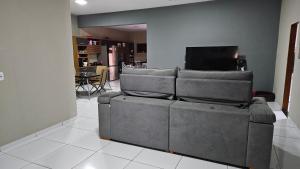 a living room with a couch and a television at Sítio Menezes in Parnaíba