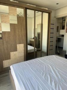a bedroom with a white bed and a mirror at Madinaty B12 in Madinaty