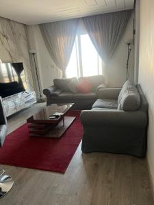 a living room with two couches and a coffee table at Madinaty B12 in Madinaty