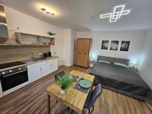 a bedroom with a bed and a table in a room at Herzstück in Ansbach
